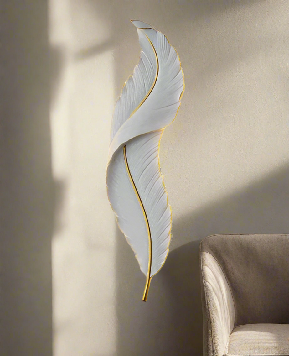 Decorative wall light shaped like a leaf with a warm glow on a neutral background