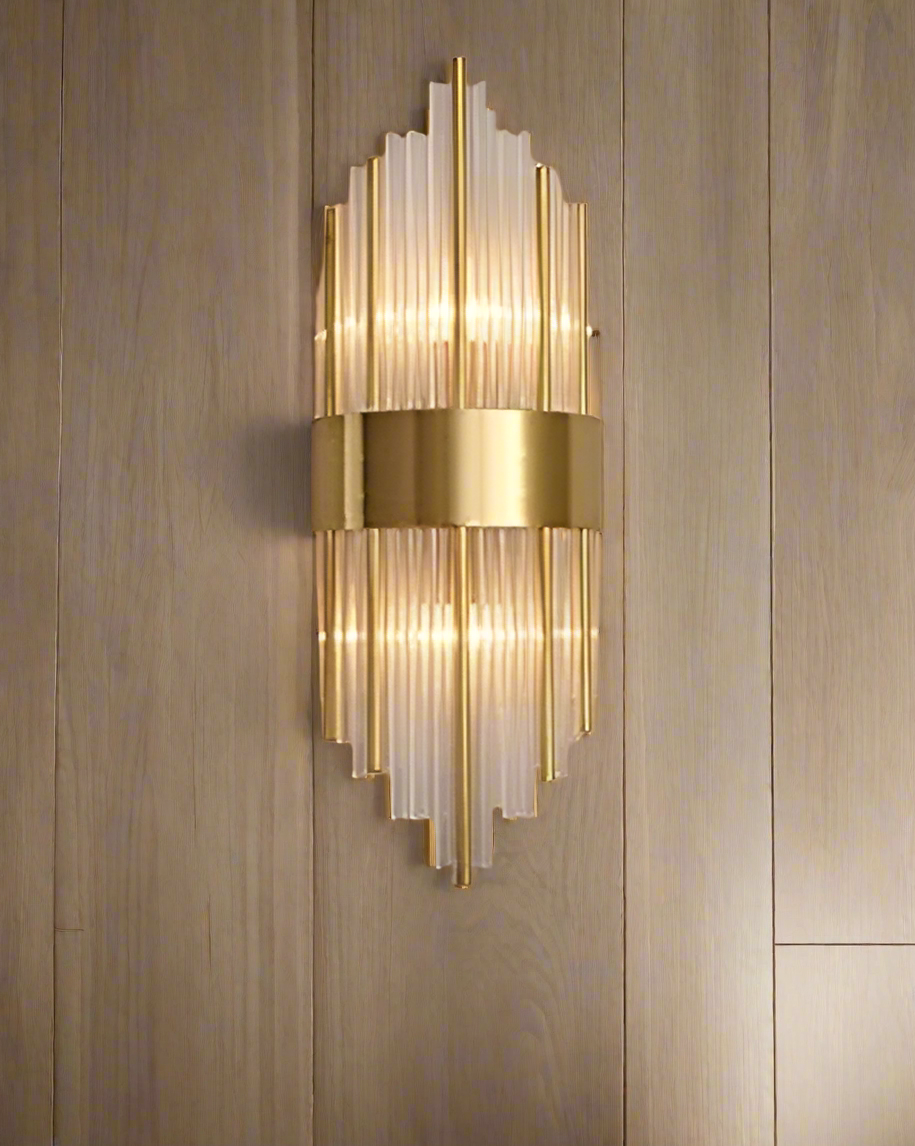 Gold wall sconce with cylindrical design 