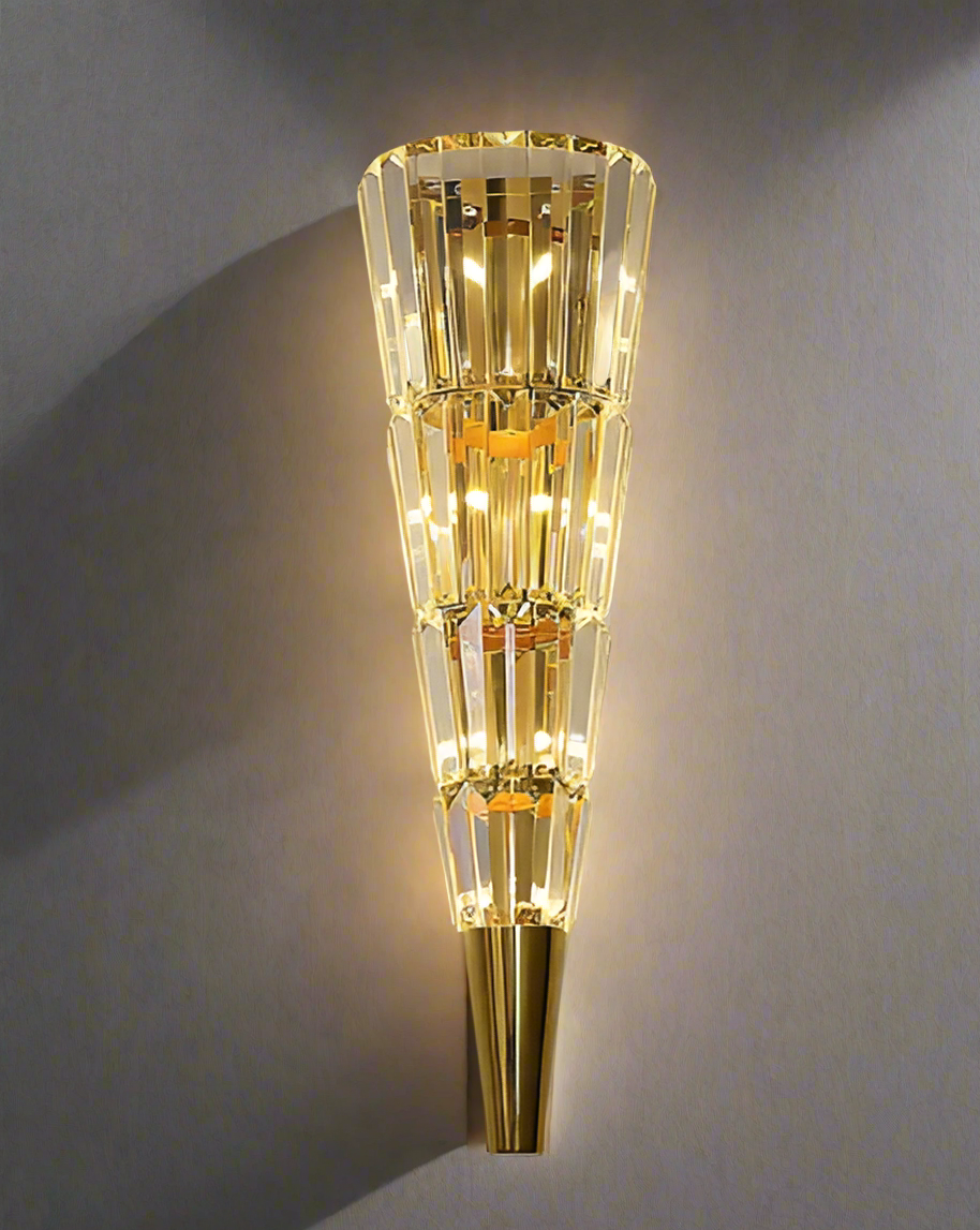 Gold wall sconce with a cone-shaped design 