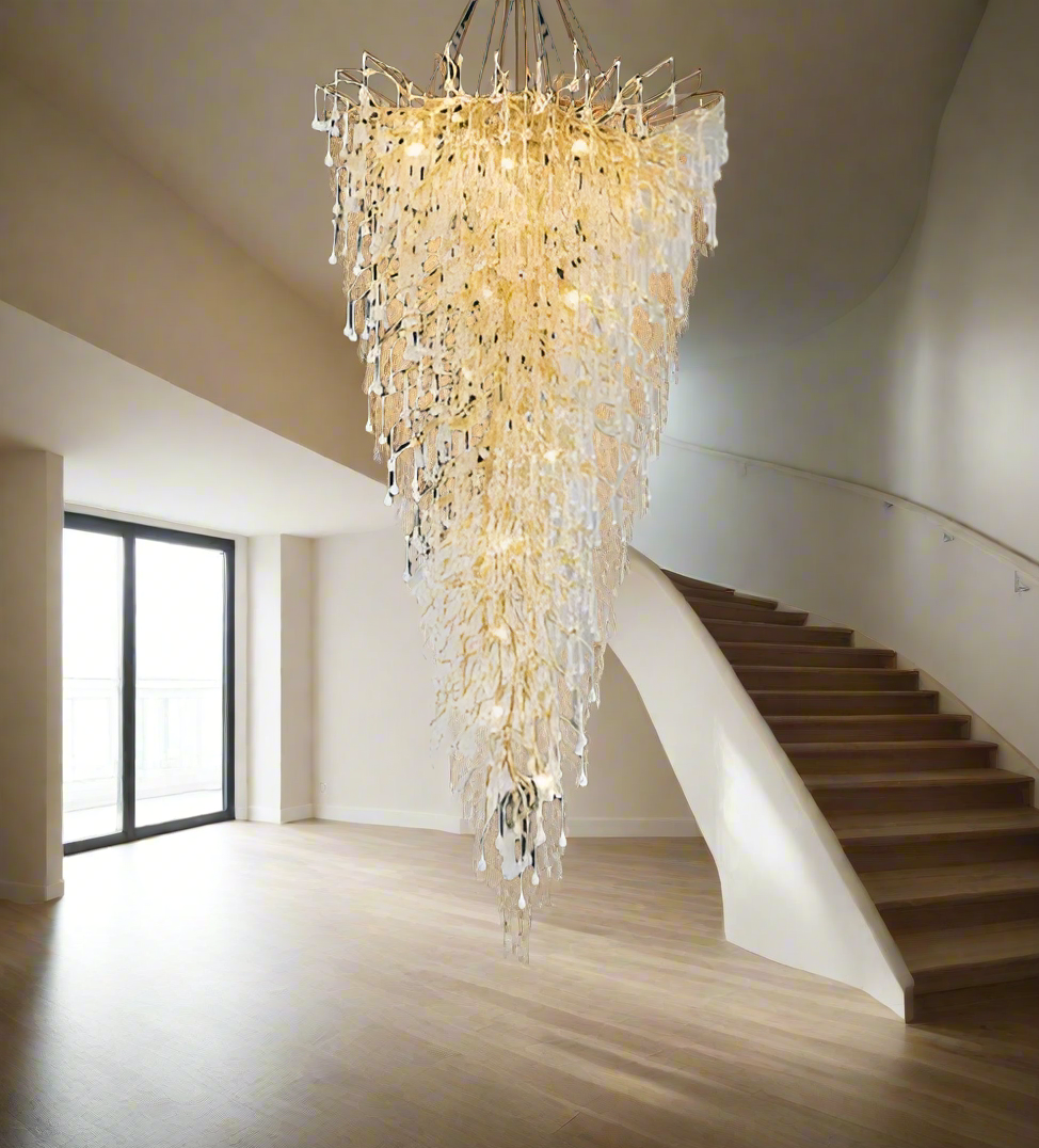 Luxurious chandelier hanging above a staircase in a modern interior setting.