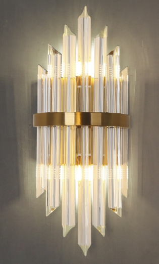 Decorative wall light fixture with clear glass panels and gold metal accents 
