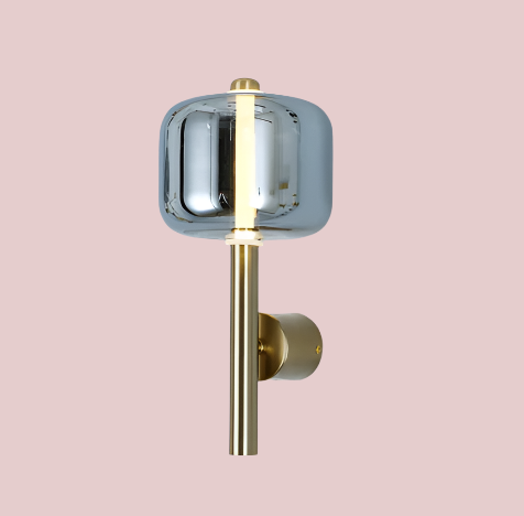 Wall-mounted light fixture with gold finish and clear glass shade on a light gray background